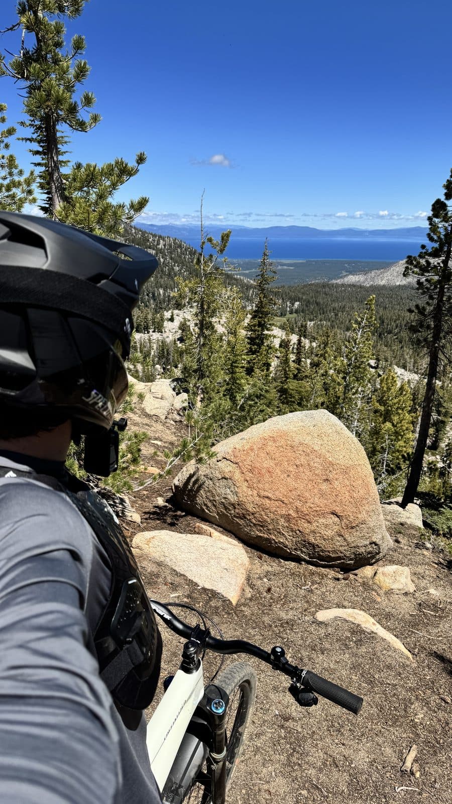 Stopped at an overlook on Mr. Toad's Wild Ride above Lake Tahoe, helmet on, bike pointed down the trail
