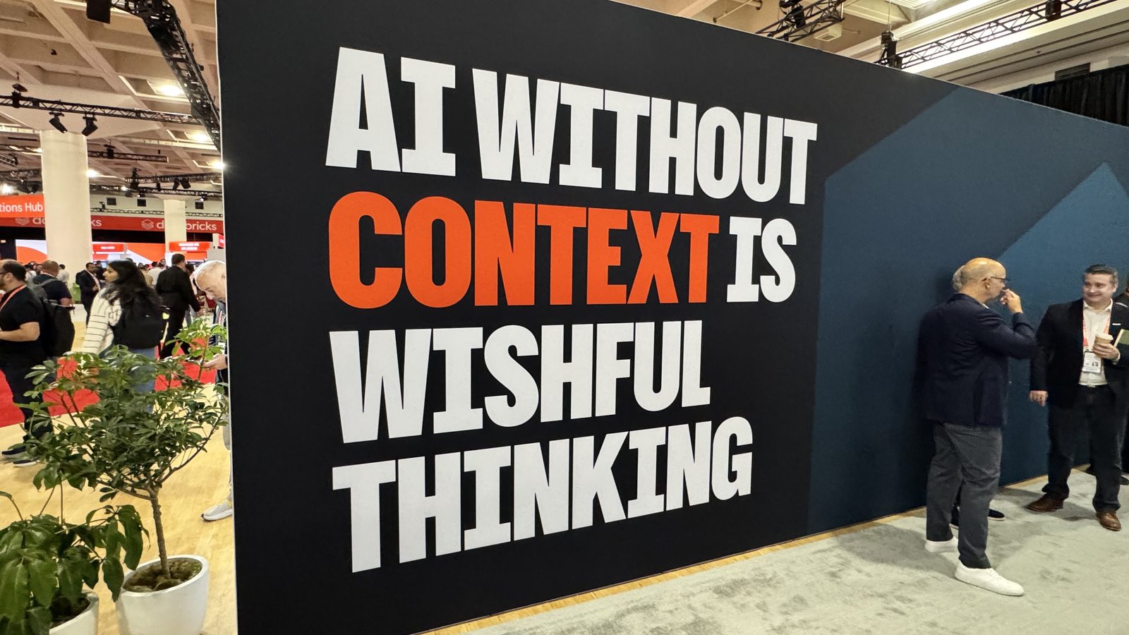 A wall at Databricks Data + AI Summit reading "AI without context is wishful thinking"